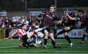 11 October 2024; Patrick Hoban of Derry City shoots under pressure from Jevon Mills and Jordan Flores of Bohemians before the SSE Airtricity Men's Premier Division match between Derry City and Bohemians at The Ryan McBride Brandywell Stadium in Derry. Photo by Ramsey Cardy/Sportsfile