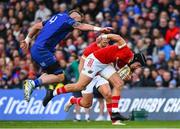 12 October 2024; Mike Haley of Munster is tackled by RG Snyman of Leinster during the United Rugby Championship match between Leinster and Munster at Croke Park in Dublin. Photo by Shauna Clinton/Sportsfile