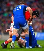 12 October 2024; Mike Haley of Munster is tackled by Garry Ringrose, left, and Jamie Osborne of Leinster during the United Rugby Championship match between Leinster and Munster at Croke Park in Dublin. Photo by Shauna Clinton/Sportsfile