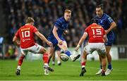12 October 2024; Ciarán Frawley of Leinster in action against Munster players Jack Crowley, left, and Mike Haley during the United Rugby Championship match between Leinster and Munster at Croke Park in Dublin. Photo by Seb Daly/Sportsfile