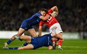 12 October 2024; Hugo Keenan, top and Garry Ringrose of Leinster tackle Jack Crowley of Munster during the United Rugby Championship match between Leinster and Munster at Croke Park in Dublin. Photo by Brendan Moran/Sportsfile
