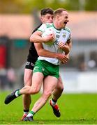 13 October 2024; David McEntee of Burren is tackled by Anthony Morgan of Kilcoo during the Down County Senior Club Football Championship final match between Burren and Kilcoo at Pairc Esler in Newry, Down. Photo by Shauna Clinton/Sportsfile