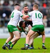 13 October 2024; Jack Devlin of Kilcoo is tackled by Burren players, from left, Malachai McAvoy, Kevin McKernan and David McEntee during the Down County Senior Club Football Championship final match between Burren and Kilcoo at Pairc Esler in Newry, Down. Photo by Shauna Clinton/Sportsfile