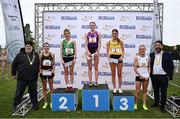 13 October 2024; Senior women's 8000m top finishers Sophie Tarver of England, first, Ide Nic Dhomhnaill of West Limerick AC, second, Fiona Everard of Bandon AC, Cork, third, Nakita Burke of Letterkenny AC, Donegal, 28, fourth, and Cheryl Nolan of St Abbans AC, Laois, 37, fifth, with Athletics Ireland president John Cronin, left, and Mayor of Fingal Councillor Brian McDonagh, during the Autumn Open International Cross Country Festival and National Juvenile Relays at the Sport Ireland National Cross Country Track in Abbotstown, Dublin. Photo by Seb Daly/Sportsfile