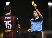 14 October 2024; Referee Rob Hennessy shows a yellow card to James Clarke of Bohemians during the SSE Airtricity Men's Premier Division match between Bohemians and St Patrick's Athletic at Dalymount Park in Dublin. Photo by Tyler Miller/Sportsfile