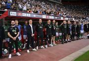 13 October 2024; Republic of Ireland staff and coaches, from left, kit and equipment manager Karl McKenna, head coach Heimir Hallgrimsson, assistant head coach John O'Shea, assistant coach Paddy McCarthy, analyst Ger Dunne, goalkeeping coach Gudmundur Hreidarsson, head of athletic performance Damien Doyle, team doctor Sean Carmody and lead physiotherapist Danny Miller stand for the playing of the National Anthem before the UEFA Nations League B Group 2 match between Greece and Republic of Ireland at Georgios Karaiskakis Football Stadium in Piraeus, Greece. Photo by Stephen McCarthy/Sportsfile