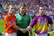 15 August 2004; Team captains Ben O'Connor, Cork, and John O'Connor, Wexford, shake hands in the presence of match referee Barry Kelly before the coin toss. Guinness Senior Hurling Championship Semi-Final, Wexford v Cork, Croke Park, Dublin. Picture credit; Brian Lawless / SPORTSFILE