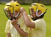 24 August 2004; Ciaran Walsh, left, from Irishtown, has his helmet adjusted by his team-mate Fionn Farrell, also from Irishtown, at the Dublin Docklands Festival of Football and Hurling, for 10-14 year olds from the Docklands area, at Parnell Park, Dublin. Picture credit; Ray McManus / SPORTSFILE