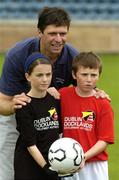 24 August 2004; The former Republic of Ireland international Niall Quinn with Niamh Filey, 13 years and Dillon Lacey, 12 years, both from Ringsend, at the Dublin Docklands Festival of Football and Hurling, for 10-14 year olds from the Docklands area, at Parnell Park, Dublin. Picture credit; Ray McManus / SPORTSFILE