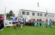 25 September 2013; Kevin McManamon, Dublin, leads out his team-mates out to the field before the GOAL Challenge charity match. Dublin Goal challenge, Parnell Park, Dublin.  Picture credit: Barry Cregg / SPORTSFILE