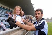25 September 2013; Caitlin Barry, eight years old, from Clonee, Co. Meath, but sporting the Dublin colours has her jersey signed by Bryan Cullen before the game. Dublin Goal challenge, Parnell Park, Dublin. Picture credit: Ray McManus / SPORTSFILE
