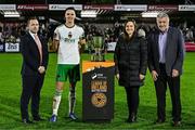 18 October 2024; Cork City captain Cian Coleman is presented with the trophy by, from left, League of Ireland director Mark Scanlon, SSE Airtricity Sponsorship manager Ashley Keating, and  FAI President Paul Cooke after the SSE Airtricity Men's First Division match between Cork City and Wexford at Turner's Cross in Cork. Photo by Sam Barnes/Sportsfile