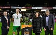 18 October 2024; Cork City captain Cian Coleman is presented with the trophy by, from left, League of Ireland director Mark Scanlon, SSE Airtricity Sponsorship manager Ashley Keating, and  FAI President Paul Cooke after the SSE Airtricity Men's First Division match between Cork City and Wexford at Turner's Cross in Cork. Photo by Sam Barnes/Sportsfile