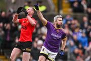 20 October 2024; Cian Ward of Wolfe Tones celebrates after scoring his side's first goal, as Mathew Costello of Dunshaughlin reacts, during the Meath County Senior Club Football Championship final match between Wolfe Tones and Dunshaughlin at Páirc Tailteann in Navan, Meath. Photo by Ben McShane/Sportsfile