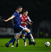 25 October 2024; Kian Leavy of St Patrick's Athletic is tackled by Shane McEleney of Derry City during the SSE Airtricity Men's Premier Division match between St Patrick's Athletic and Derry City at Richmond Park in Dublin. Photo by Tyler Miller/Sportsfile