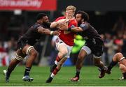 26 October 2024; Ethan Coughlan of Munster is tackled by Vincent Tshituka and Jaden Hendrikse of Hollywoodbets Sharks during the United Rugby Championship match between Hollywoodbets Sharks and Munster at Hollywoodbets Kings Park in Durban, South Africa. Photo by Shaun Roy/Sportsfile