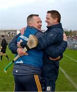 26 October 2024; Ireland manager Michael Kavanagh, Kevin O'Brien, hidden, and Damien Coleman, right, celebrate after the Shinty International match between Ireland and Scotland at Cusack Park in Ennis, Clare. Photo by Ray McManus/Sportsfile