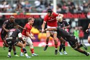 26 October 2024; Mike Haley of Munster is tackled by Vincent Tshituka of Hollywoodbets Sharks during the United Rugby Championship match between Hollywoodbets Sharks and Munster at Hollywoodbets Kings Park in Durban, South Africa. Photo by Shaun Roy/Sportsfile