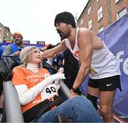 27 October 2024; Actor Colin Farrell with Emma Fogarty after finishing the 2024 Irish Life Dublin Marathon. This marks the 43rd edition of the race with thousands of participants from international athletes, club runners, wheelchair-assisted participants, charity runners, and first-time marathon participants taking on the 26.2-mile challenge. This year’s race started on Leeson Street and finished at the Pepper Canister Church on Mount Street Upper. Photo by Sam Barnes/Sportsfile