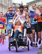 27 October 2024; Actor Colin Farrell with Emma Fogerty celebrate on their way to finishing the 2024 Irish Life Dublin Marathon. This marks the 43rd edition of the race with thousands of participants from international athletes, club runners, wheelchair-assisted participants, charity runners, and first-time marathon participants taking on the 26.2-mile challenge. This year’s race started on Leeson Street and finished at the Pepper Canister Church on Mount Street Upper. Photo by Sam Barnes/Sportsfile