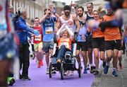 27 October 2024; Actor Colin Farrell with Emma Fogerty celebrate on their way to finishing the 2024 Irish Life Dublin Marathon. This marks the 43rd edition of the race with thousands of participants from international athletes, club runners, wheelchair-assisted participants, charity runners, and first-time marathon participants taking on the 26.2-mile challenge. This year’s race started on Leeson Street and finished at the Pepper Canister Church on Mount Street Upper. Photo by Sam Barnes/Sportsfile