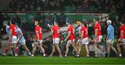 27 October 2024; Adam English of Doon, 11, dries his hurl as he walks in the parade before the Limerick County Senior Club Hurling Championship final match between Na Piarsaigh and Doon at TUS Gaelic Grounds in Limerick. Photo by Ray McManus/Sportsfile