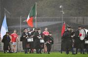 27 October 2024; Darragh O'Donovan of Doon leads his players behind the Tricolour carried by a member of the CBS Pipe Band before the Limerick County Senior Club Hurling Championship final match between Na Piarsaigh and Doon at TUS Gaelic Grounds in Limerick. Photo by Ray McManus/Sportsfile