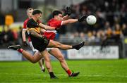27 October 2024; Michéal Burns of Dr Crokes kicks a point despite the efforts of Seán Óg Moran of Dingle during the Kerry County Senior Club Football Championship final match between Dingle and Dr Crokes at Austin Stack Park in Tralee, Kerry. Photo by Brendan Moran/Sportsfile