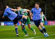 28 October 2024; Cristian Magerusan of Bray Wanderers in action against Eanna Clancy, left, and Ronan Finn of UCD during the SSE Airtricity Men's First Division play-off semi-final second leg match between UCD and Bray Wanderers at UCD Bowl in Dublin. Photo by Stephen McCarthy/Sportsfile