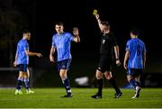 28 October 2024; Eanna Clancy of UCD is shown a yellow card by referee Declan Toland during the SSE Airtricity Men's First Division play-off semi-final second leg match between UCD and Bray Wanderers at UCD Bowl in Dublin. Photo by Stephen McCarthy/Sportsfile