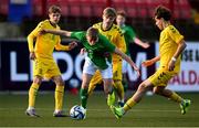 29 October 2024; Michael Noonan of Republic of Ireland in action against Lithuania players, from left, Justas Rakauskas, Jugas Turcinskas and Simas Grabauskas during the UEFA U17 European Championships Round 1 Qualifier match between Republic of Ireland and Lithuania at Inver Park in Larne, Antrim. Photo by Ramsey Cardy/Sportsfile