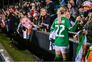 29 October 2024; Republic of Ireland supporters, holding a cardboard cut out of Izzy Atkinson of Republic of Ireland, await their turn to get her autograph, after the UEFA Women's EURO 2025 Play-Off Round 1 second leg match between Republic of Ireland and Georgia at Tallaght Stadium in Dublin. Photo by Ben McShane/Sportsfile