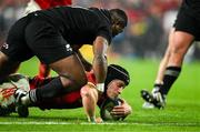 2 November 2024; Mike Haley of Munster scores his side's first try despite the tackle of Kini Naholo of All Blacks XV during the match between Munster and All Blacks XV at Thomond Park in Limerick. Photo by Brendan Moran/Sportsfile