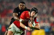 2 November 2024; Mike Haley of Munster is tackled by Kini Naholo of All Blacks XV on the way to scoring his side's first try during the match between Munster and All Blacks XV at Thomond Park in Limerick. Photo by Brendan Moran/Sportsfile