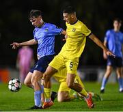 6 November 2024; Lorcan Moore of UCD in action against Lis Berisha of 2 Korriku during the UEFA Youth League second round 2nd leg match between UCD and 2 Korriku at UCD Bowl in Dublin. Photo by Tyler Miller/Sportsfile