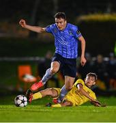 6 November 2024; Jake Doyle of UCD is tackled by Enes Hajrullahu of 2 Korriku during the UEFA Youth League second round 2nd leg match between UCD and 2 Korriku at UCD Bowl in Dublin. Photo by Tyler Miller/Sportsfile