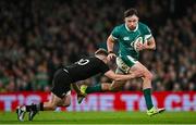 8 November 2024; Hugo Keenan of Ireland is tackled by Damian McKenzie of New Zealand during the Autumn Nations Series match between Ireland and New Zealand at the Aviva Stadium in Dublin. Photo by Seb Daly/Sportsfile