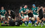 8 November 2024; Rónan Kelleher of Ireland is tackled by New Zealand players Rieko Ioane, left, and Tupou Vaa’i during the Autumn Nations Series match between Ireland and New Zealand at the Aviva Stadium in Dublin. Photo by Brendan Moran/Sportsfile