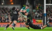 8 November 2024; Joe McCarthy of Ireland is tackled by New Zealand players Rieko Ioane, left, and Wallace Sititi during the Autumn Nations Series match between Ireland and New Zealand at the Aviva Stadium in Dublin. Photo by Sam Barnes/Sportsfile