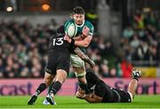 8 November 2024; Joe McCarthy of Ireland is tackled by New Zealand players Rieko Ioane, left, and Wallace Sititi during the Autumn Nations Series match between Ireland and New Zealand at the Aviva Stadium in Dublin. Photo by Sam Barnes/Sportsfile