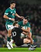 8 November 2024; James Lowe of Ireland is tackled by Damian McKenzie of New Zealand during the Autumn Nations Series match between Ireland and New Zealand at the Aviva Stadium in Dublin. Photo by Brendan Moran/Sportsfile