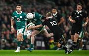 8 November 2024; Mack Hansen of Ireland is tackled by Damian McKenzie of New Zealand during the Autumn Nations Series match between Ireland and New Zealand at the Aviva Stadium in Dublin. Photo by Brendan Moran/Sportsfile