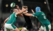 8 November 2024; Damian McKenzie of New Zealand is tackled by James Lowe, left, and Tadgh Beirne of Ireland during the Autumn Nations Series match between Ireland and New Zealand at the Aviva Stadium in Dublin. Photo by Sam Barnes/Sportsfile