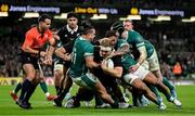 8 November 2024; Sam Cane of New Zealand is tackeld in the in goal area by James Lowe and Bundee Aki of Ireland during the Autumn Nations Series match between Ireland and New Zealand at the Aviva Stadium in Dublin. Photo by Brendan Moran/Sportsfile