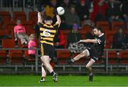 9 November 2024; Conor Laverty of Kilcoo kicks a point despite the attention of Conor Rehill of Crosserlough during the AIB Ulster GAA Senior Club Football Championship quarter-final match between Kilcoo and Crosserlough at Páirc Esler in Newry, Down. Photo by Ben McShane/Sportsfile