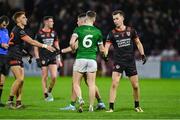 10 November 2024; Sean McCarthy of Clann Éireann commiserates with Patrick McMullan of Newbridge after the AIB Ulster GAA Senior Club Football Championship quarter-final match between Sean O'Leary GAC Newbridge and Clann Éireann at Celtic Park in Derry. Photo by Oliver McVeigh/Sportsfile