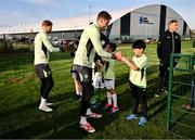 11 November 2024; Goalkeepers Mark Travers, right, and Caoimhin Kelleher with the winners of the Elverys Sports competition before the FAI National Training Centre in Abbotstown, Dublin. Photo by Ben McShane/Sportsfile