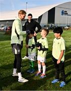 11 November 2024; Goalkeeper Caoimhin Kelleher with the winners of the Elverys Sports competition before before the FAI National Training Centre in Abbotstown, Dublin. Photo by Ben McShane/Sportsfile