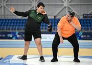 16 November 2024; James Egan from Ferbane, Offaly, tries out shot put with the help of VI Para Hub coordinator Tracey Percy during the PTSB NextGen Community Series at the National Indoor Arena on the Sport Ireland Campus in Dublin. Paralympics Ireland hosted the latest in the PTSB NextGen Community Series at the Sport Ireland National Indoor Arena on Saturday. This programme is open to people over 10 with a visual, intellectual, or physical impairment, allowing them to ‘come and try’ Para sports and learn about opportunities in their local areas. Photo by Seb Daly/Sportsfile