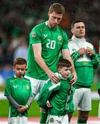 17 November 2024; Mark McGuinness of Republic of Ireland gives his jacket to his mascot before the UEFA Nations League B Group 2 match between England and Republic of Ireland at Wembley Stadium in London, England. Photo by Harry Murphy/Sportsfile